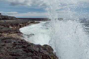 Atlantic ocean, coast of Inishmore, Aran Islands, County Galway, Ireland. Irish landscape. Powerful wave. Cloudy sky