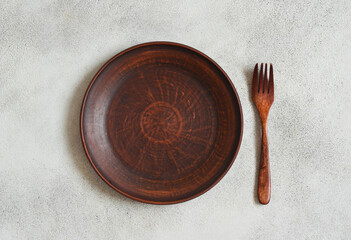 eco friendly handmade ceramic tableware top view with copy space for text and design, clay empty plate flat lay, cutlery and table setting, minimalism and ceramics tableware