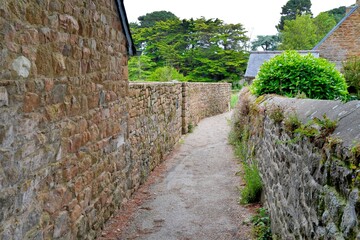 Fototapeta na wymiar Little street with walls in stones on the Brehat island in Brittany France