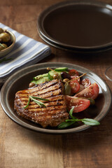 Grilled Turkey Breast with fresh salad. Wooden background. Copy space. 