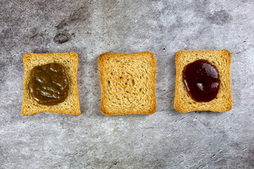 three rusks slices lined different because with different jam