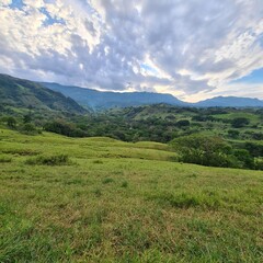 Fototapeta na wymiar Rural landscape with trees and cloudy sky. Tamesis, Antioquia, Colombia.