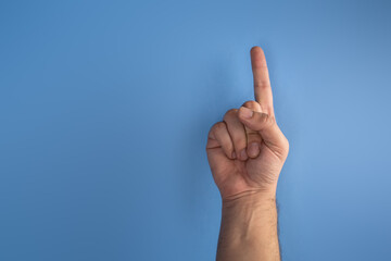 hand on blue screen making number 1