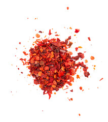 Dried red chili flakes with seeds, isolated on white background. Chopped chilli cayenne pepper. Spices and herbs. Top view.