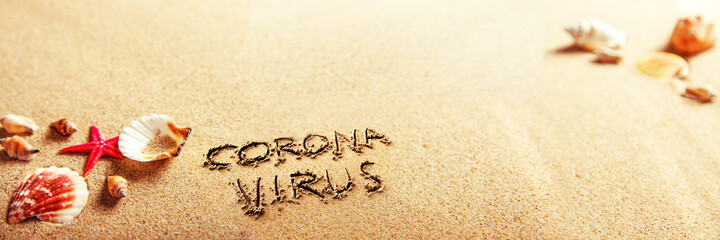 Fototapeta na wymiar Corona virus written in the sand on vacation