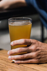 person holding a glass of cold beer in the bar