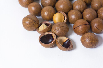 Macadamia nuts on white background. Cracked macadamia - organic and healthy food