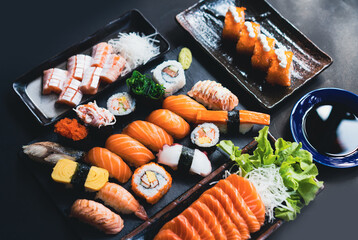 Salmon Sashimi in Japanese buffet restaurant menu.Fresh salmon sushi.Asian friends people using chopsticks eating sashimi sushi set Japan in restaurant.Asian Food Menu.seafood sashimi.People and food