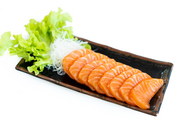 Salmon Sashimi in Japanese buffet restaurant menu.Fresh salmon fillet on black plate salmon slices.Asian people eating sashimi set Japan restaurant.salmon sashimi.Asian Food Menu.seafood sashimi.