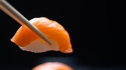 Salmon Sashimi in Japanese buffet restaurant menu.Fresh salmon sushi.Asian friends people using chopsticks eating sashimi sushi set Japan in restaurant.Asian Food Menu.seafood sashimi.People and food - obrazy, fototapety, plakaty