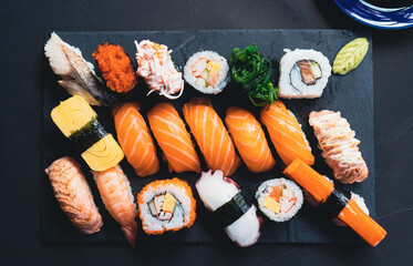 Salmon Sashimi in Japanese buffet restaurant menu.Fresh salmon fillet on black plate salmon slices.Asian people eating sashimi set Japan restaurant.salmon sashimi.Asian Food Menu.seafood sashimi.