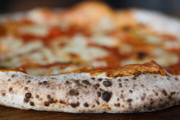 Italian pizza Napoletana on wooden table