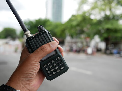security guard hand holding radio communication or walkie-talkie radio.
