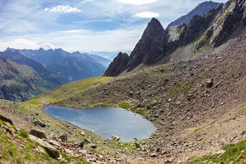 Hiking trail in Valpelline, Aosta, Italy. Panorama of Lake of Mont Rouge at 2650 meters of altitude.