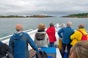 Group of people walking on the dike for boarding in the brehat island boats