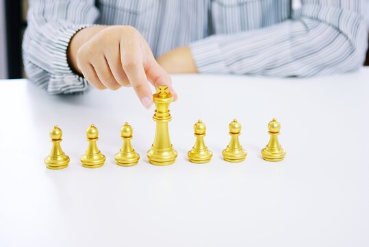 Human resources concept career management with clasped hands planning strategy with chess figures.