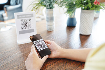 Online money, Close up hand holding smart phone for scanning Qr code for digital payment..