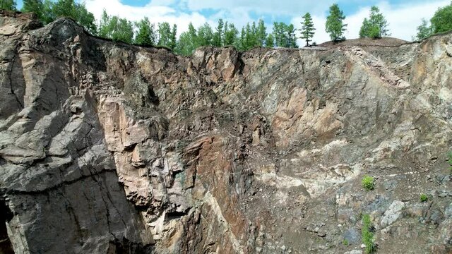 rocky mountain cliff, takeoff up on fractional, aerial video. Forests and mountains of Khakassia, Tuimsky failure. siberian nature and beautiful views