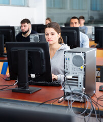 Portrait of students at computers in university computer class
