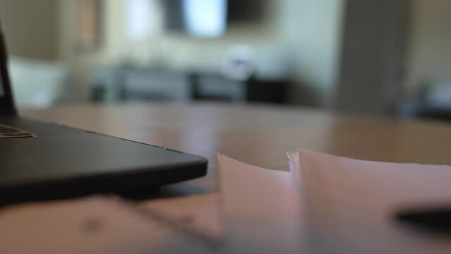 This POV Video Shows A Close Up View Of A Hand Grabbing A Coffee Mug From A Home Office Desk Covered With Paperwork And A Computer.