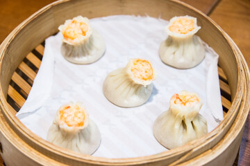 Xiaolongbao, Chinese steamed bun in small bamboo basket.