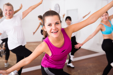 Naklejka na ściany i meble Cheerful different ages women learning swing steps at dance class