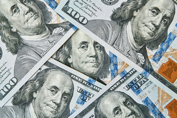 Magnifying glass on dollars bills background. One hundred dollar usd banknotes. Economic and...