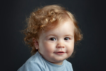 Baby portrait, close up head of cute child. Isolated on black studio.