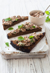 Open face sandwishes with tuna pate on rye bread close up