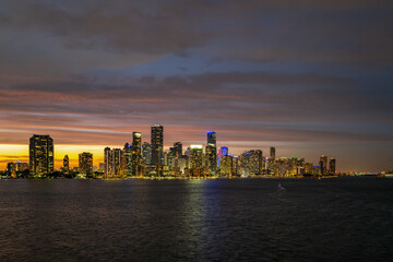Obraz na płótnie Canvas Miami city. Miami skyline panorama at dusk with skyscrapers over sea. Night downtown sanset.