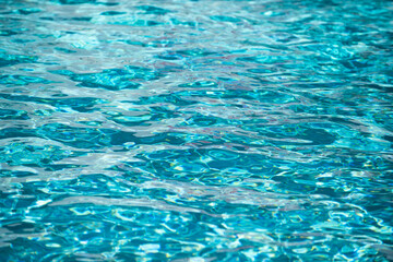 Abstract ripple wave and clear turquoise water surface in swimming pool, blue water wave for background and abstract design.