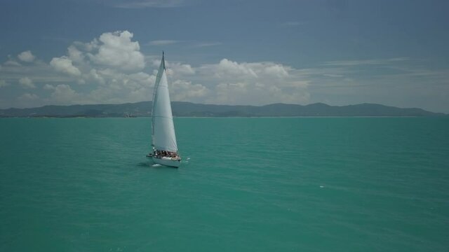 Yacht scene of sailboat - taken with drone - koh samui in Thailand -drone pulling back from boat