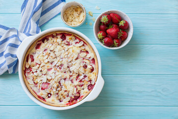 Homemade rustic strawberry cake on blue  wooden table