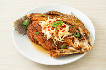 Fried Sea Bass Fish with Fish Sauce and Spicy Salad