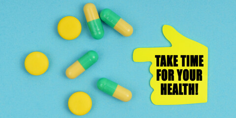 On a blue background, there are pills and a hand-sticker with the inscription - Take time for your health