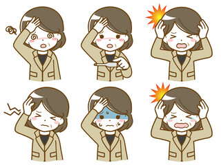 頭が痛いスーツの中年女性