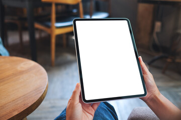 Mockup image of a woman holding digital tablet with blank white desktop screen