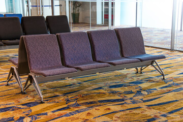 A row of chair at the lobby of airport