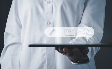 CONTACT US, Customer support, Customer service concept. Businessman holding tablet with ( mail,phone,email ) icon ,copy space.