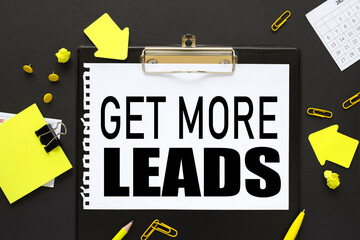 Get More Leads, text on a black background, on a black folder, on white paper, near bright stickers