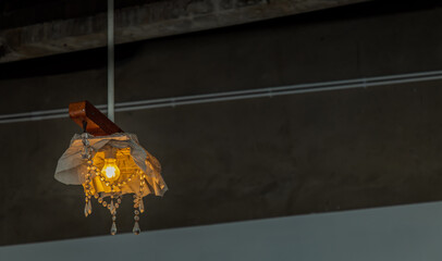 Decorating hanging ceiling design lighting bulb. Orange warm tone light color bulb light with dark...