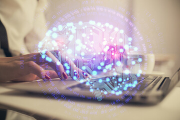 Multi exposure of woman hands working on computer and human brain hologram drawing. Ai tech concept.