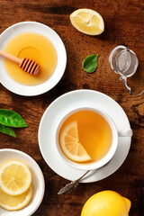 Lemon tea with honey, overhead flat lay shot. Healthy organic citrus detox beverage, natural remedy for cold and flu