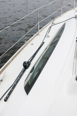 Boat trip on the river. Details about the sailing yacht. In the summer we go by boat. A white yacht with full sails. Leisure, sports, recreation theme. close-up of the ship's side