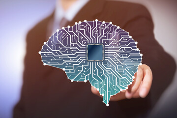 Businessman with Artificial Intelligence brain connects to technology network concept.