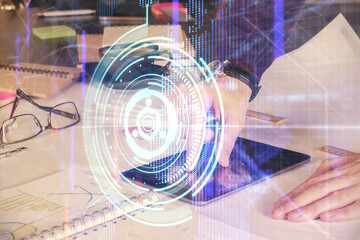 Double exposure of man's hand holding and using a digital device and data theme drawing. Technology concept.