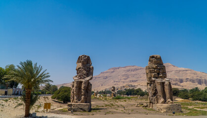 Panorama view of the Colossi of Memnon statues at the entrance of Luxor, Egypt