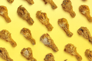 Background with fried chicken legs. Template on the theme of fast food in pastel colors.