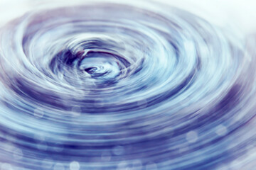 Abstract blurred background with rotating turbulent vortex. Crystal blue high-gloss shades with...