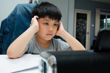 Boy listening to his teacher on video call